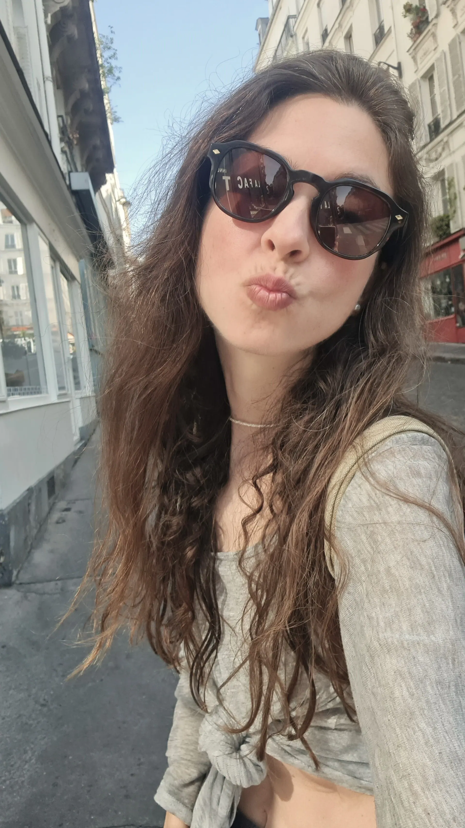 Selfie of Ece in sunglasses on a city street