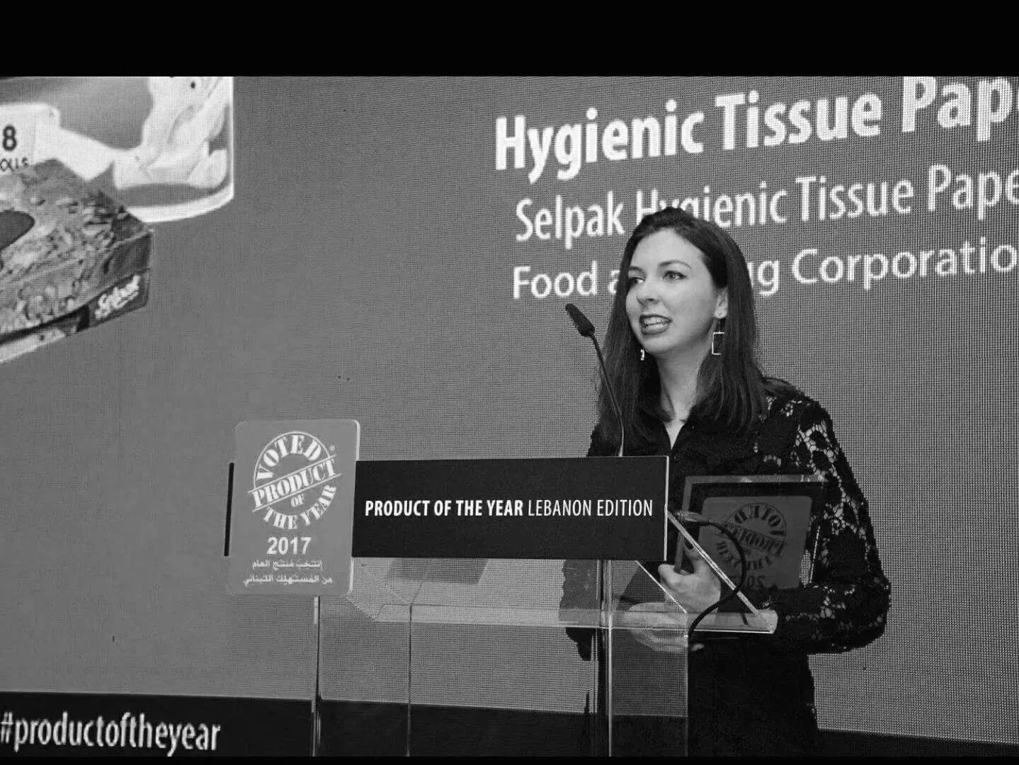 Ece speaking at the Product of the Year Lebanon Edition 2017 awards, holding an award at the lectern